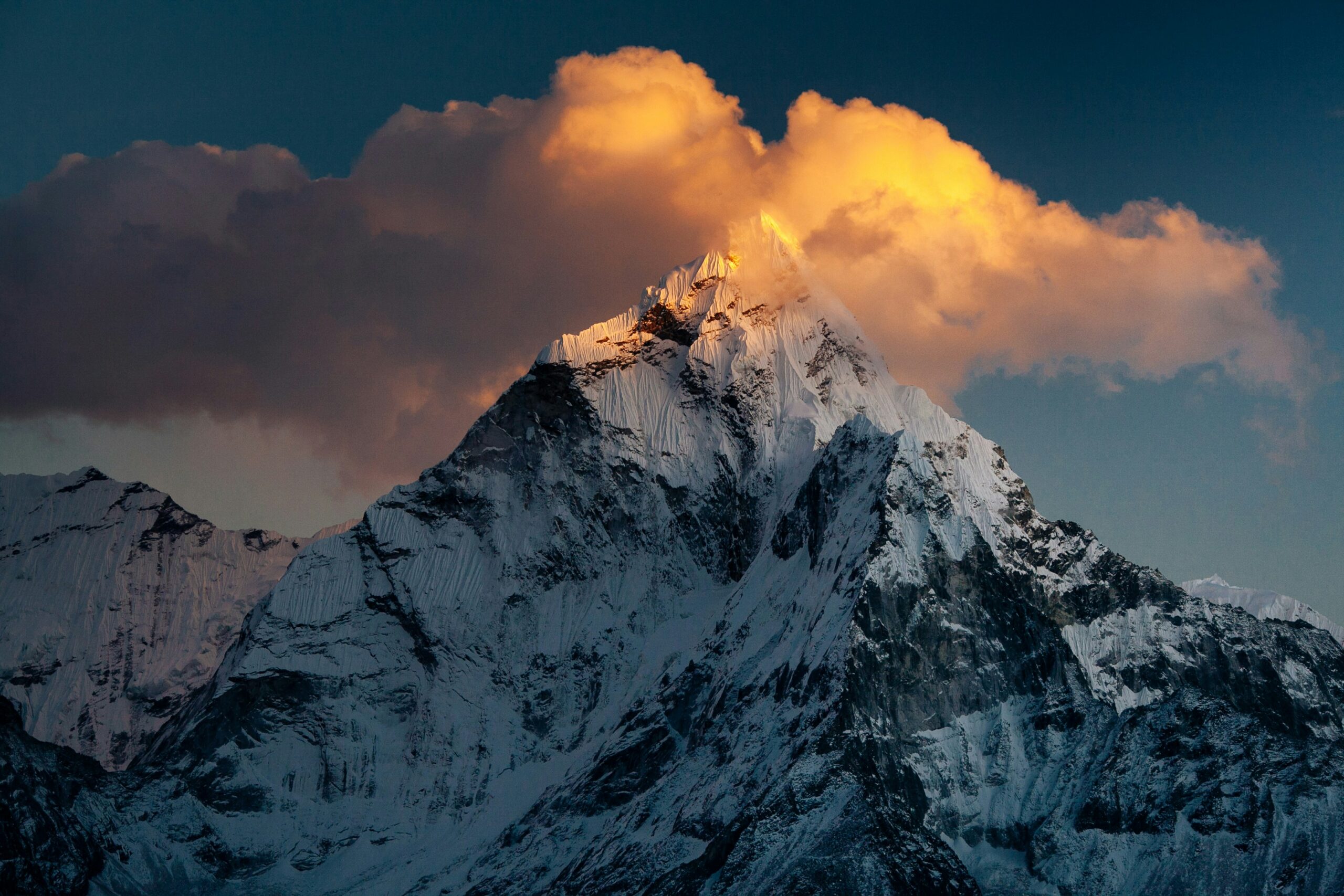 Image of a mountain peak with clouds behind it. The front cover of the Peakspective newsletter.